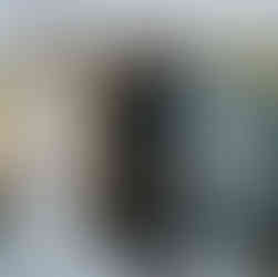 African American couple exchanging rings during outdoor farm wedding.