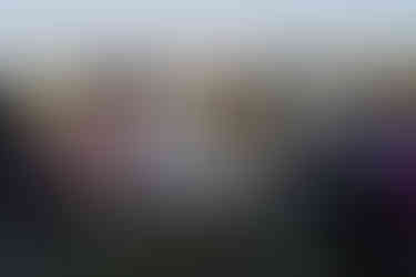 Intimate farm wedding ceremony with bride, groom, officiant, and seated guests.