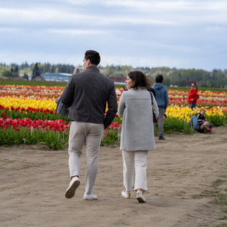 Couple walking through colorful tulips at Skagit Tulip Festival