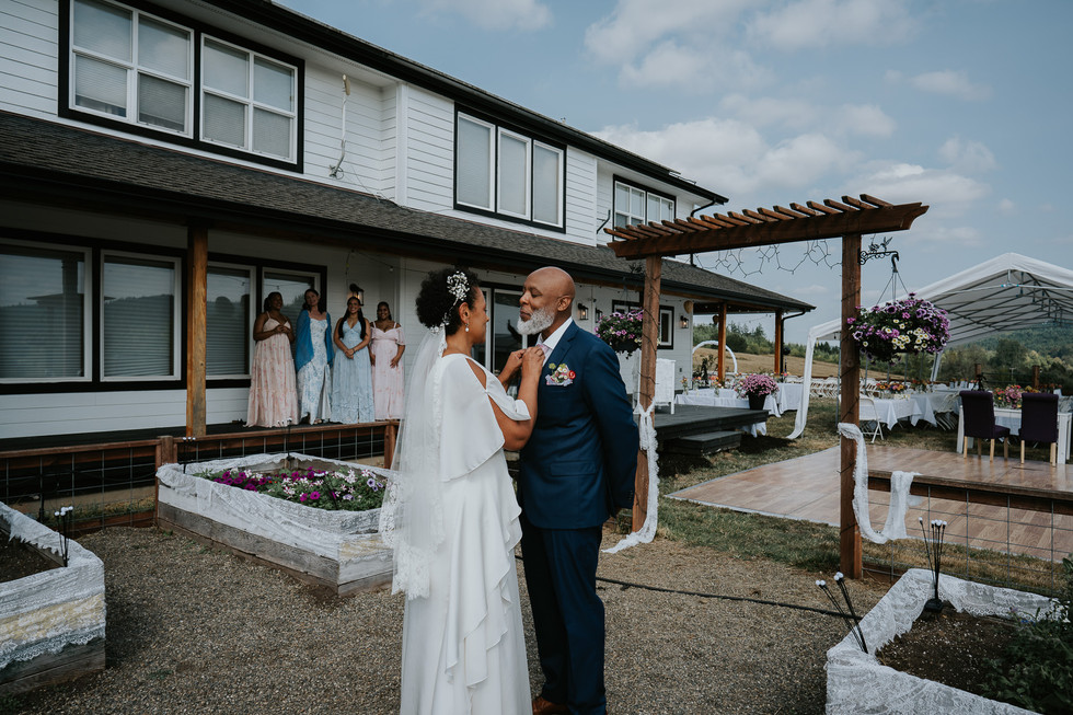 Couple lovingly gazes at each other during their outdoor farm wedding.