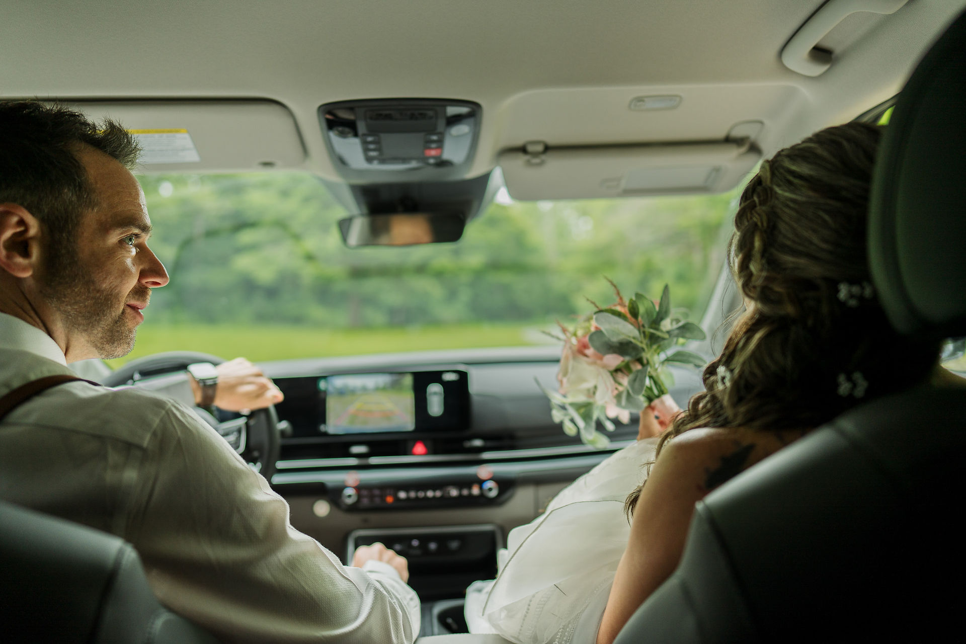 Bride and groom in a car at Forest Creek Darrington WA