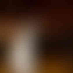 Happy bride and groom first dance at rustic wedding reception.