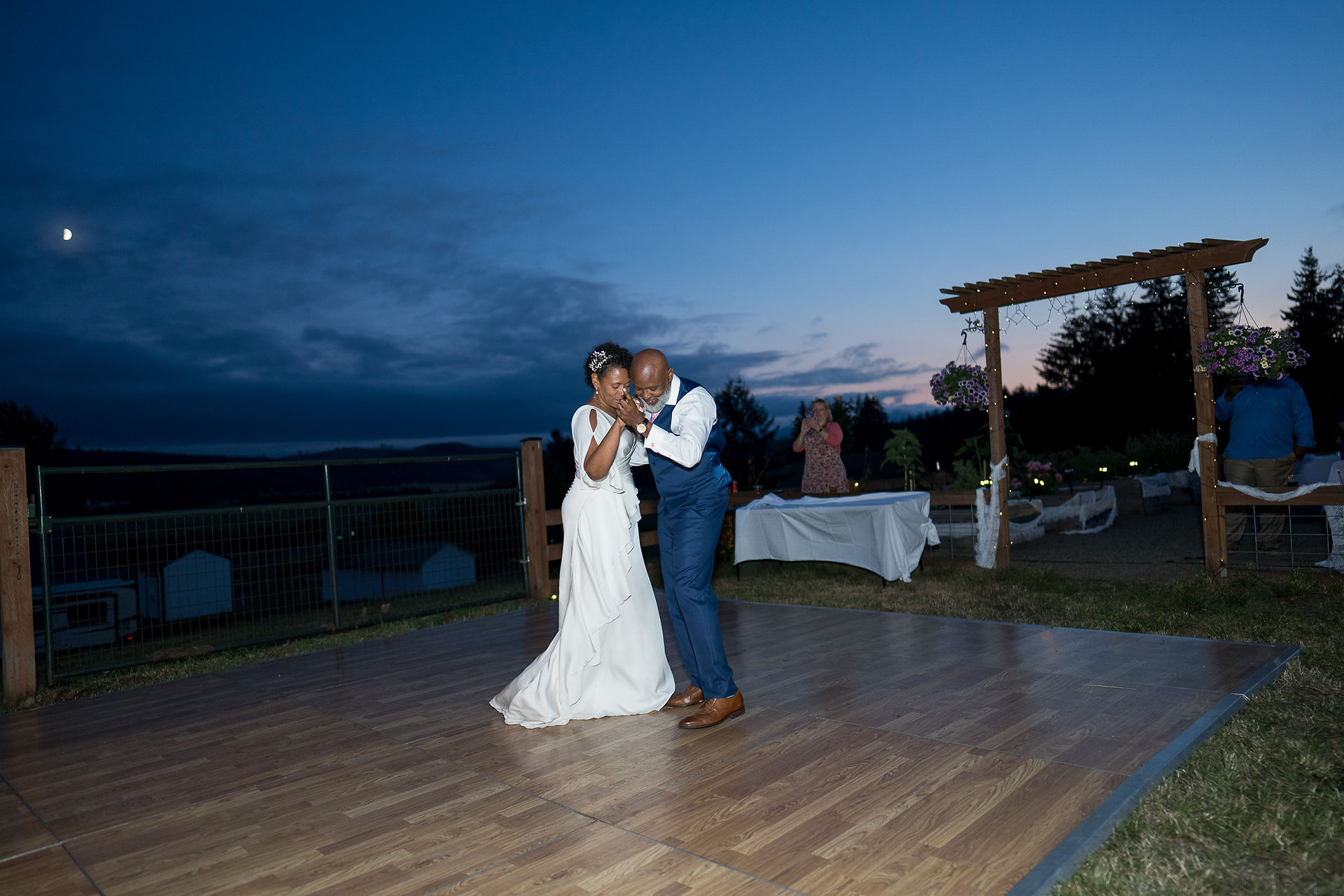 Bride and groom dancing on an outdoor floor at their intimate farm wedding.