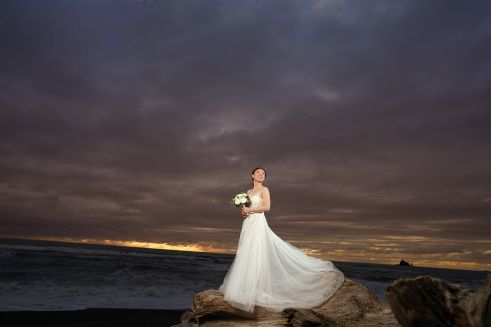 Bride on rocks at Ruby Beach for an Olympic National Park elopement