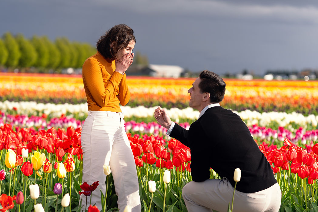 Man proposes to woman in tulip field engagement PhotoYari Photography