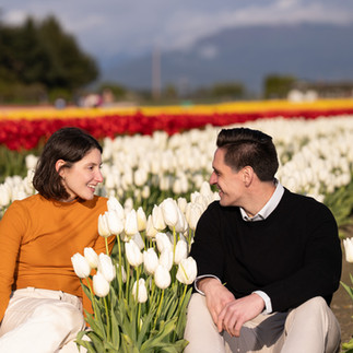 Couple gazing lovingly in white tulips at Skagit Tulip Festival