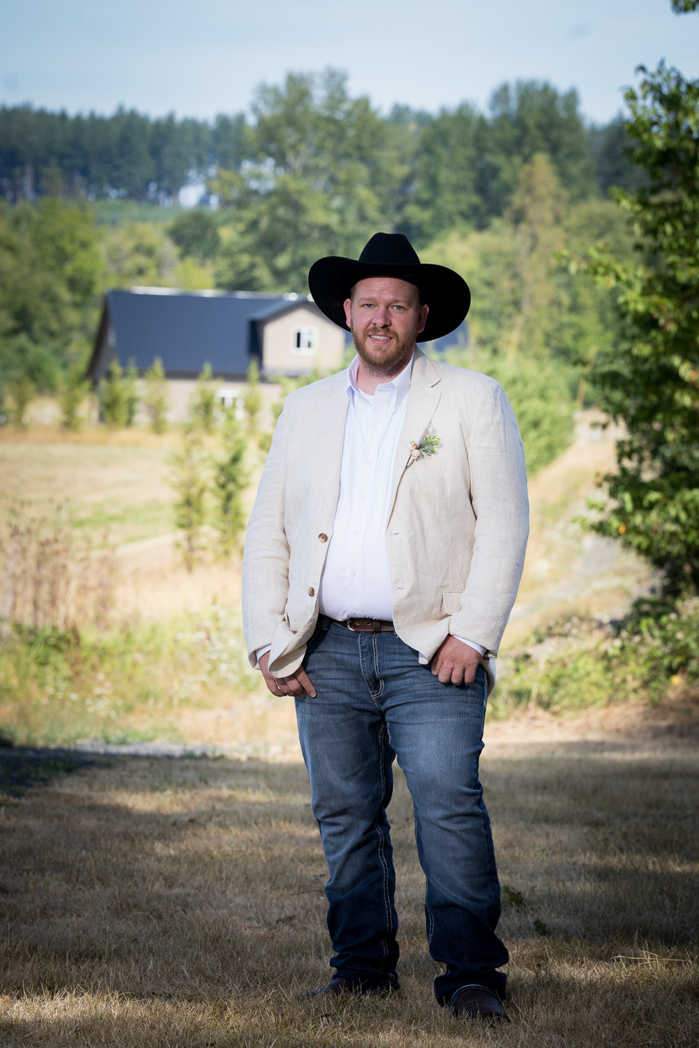 Man in cowboy hat, boutonniere, Wedding at The Barn on Jackson Chehalis WA.