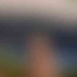 Golden Retriever dog in bandana by lake