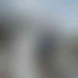 Smiling groom looks at bride at their intimate outdoor farm wedding.