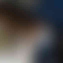 Smiling bride feeds groom cupcake at their intimate outdoor wedding.