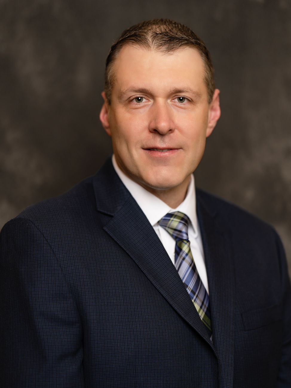 Headshot: Man in suit and tie