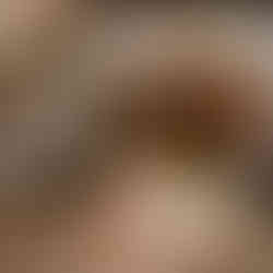 Woman speaking, man holds "Cranium" game box at elegant reception.