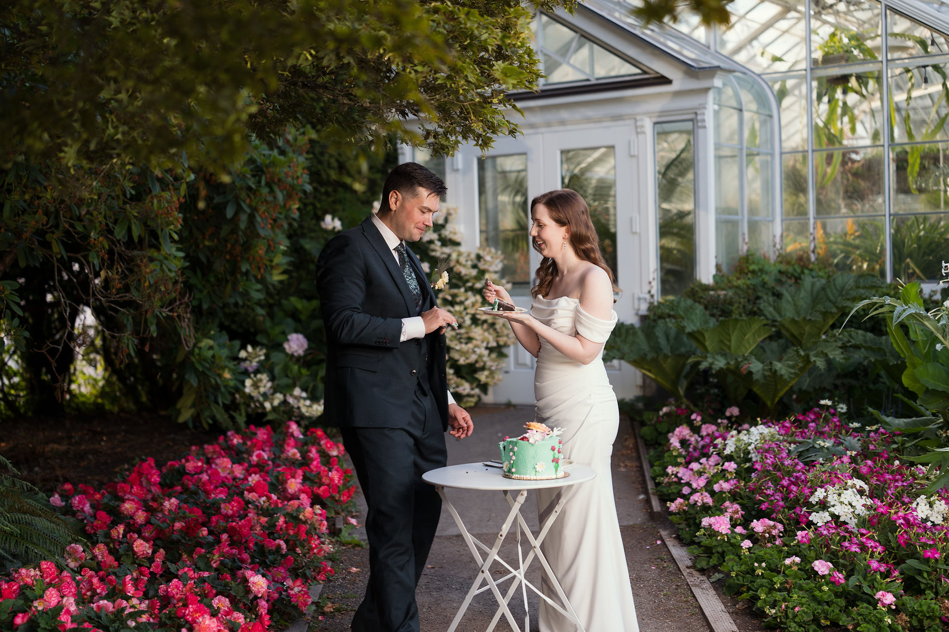 Couple cutting cake at Volunteer Park Conservatory in Seattle.
