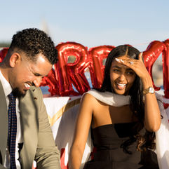 Happy couple announces engagement on boat, Marry balloons