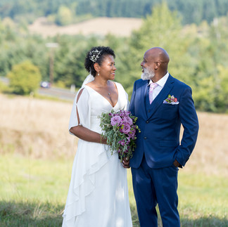Bride and groom exchanging loving glances during their intimate farm wedding.