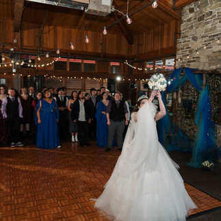 Bride throwing bouquet at a Gold Mountain Golf Club wedding.