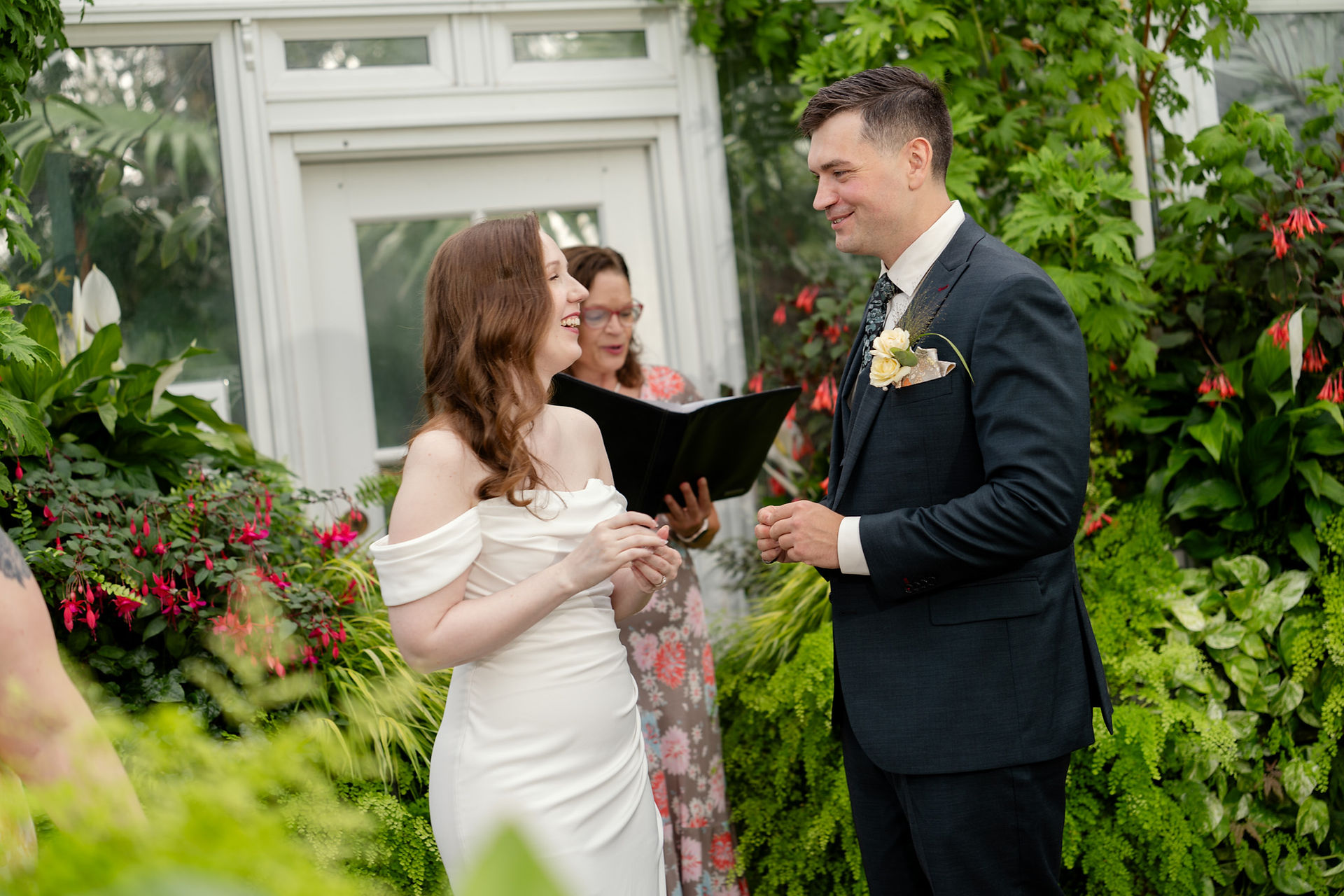 Couple exchanging vows at Volunteer Park Conservatory in Seattle.