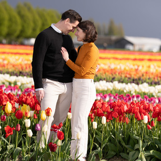 Couple embracing in a colorful tulip field at the Skagit Tulip Festival