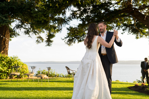 Bride and groom dancing under a tree overlooking water, Wedding on Camano Island.