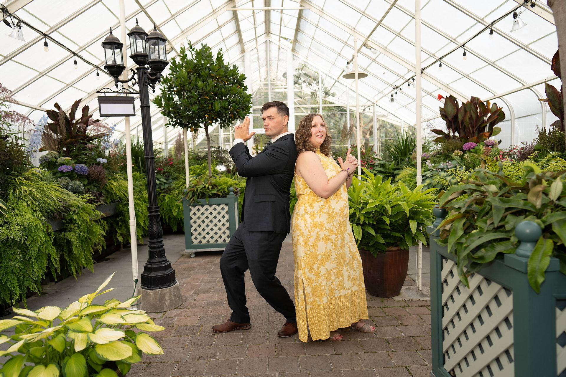 Fun couple posing at Volunteer Park Conservatory in Seattle.
