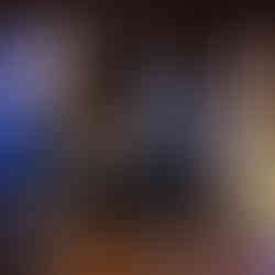 Guests dance energetically at a lively wedding reception venue indoors.