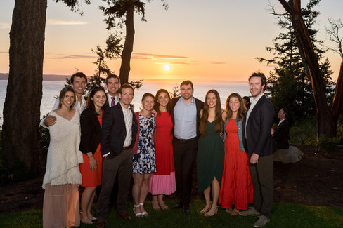 Smiling guests at an outdoor sunset celebration on Camano Island.
