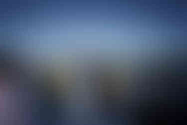 Bride and groom exchanging vows under arch at outdoor farm wedding.