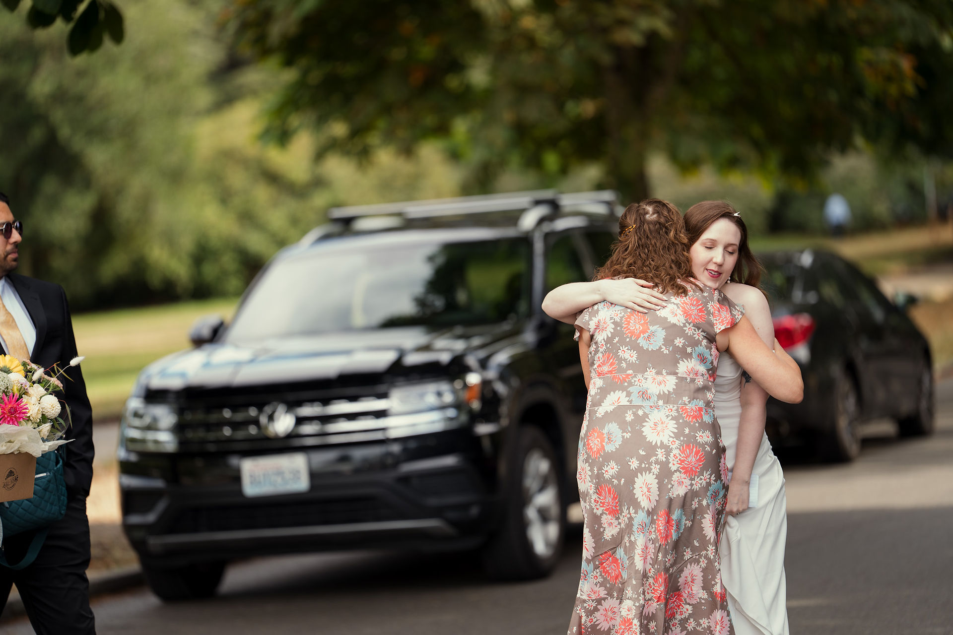 Bride hugging a guest at Volunteer Park Conservatory in Seattle.