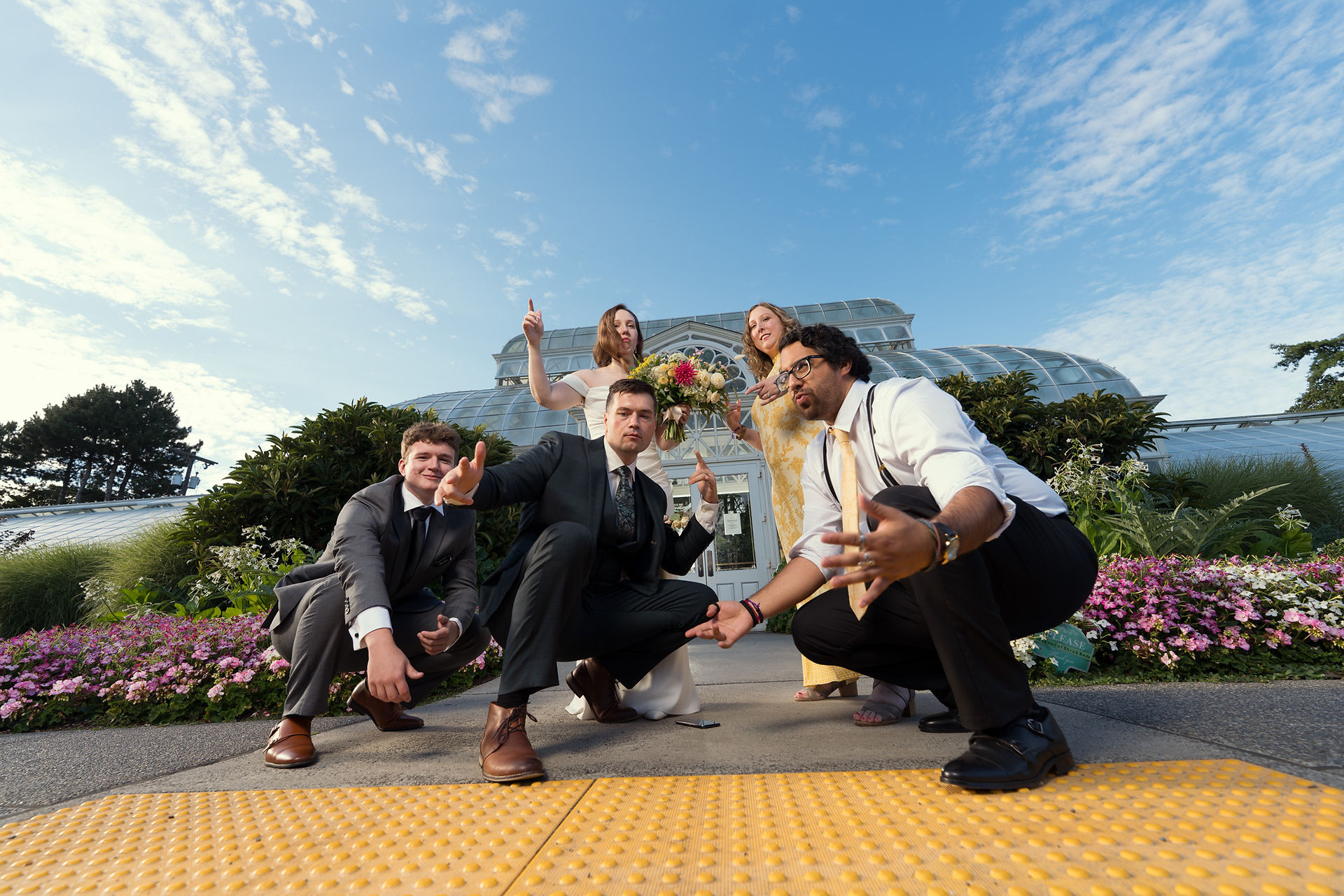 Wedding party posing at Volunteer Park Conservatory in Seattle.
