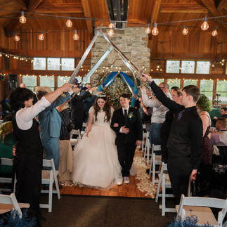 Wedding couple under swords at Gold Mountain Golf Club wedding