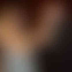 Happy couple dancing, smiling at each other at a wedding reception.