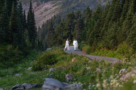 Couple walking down mountain road, elopement