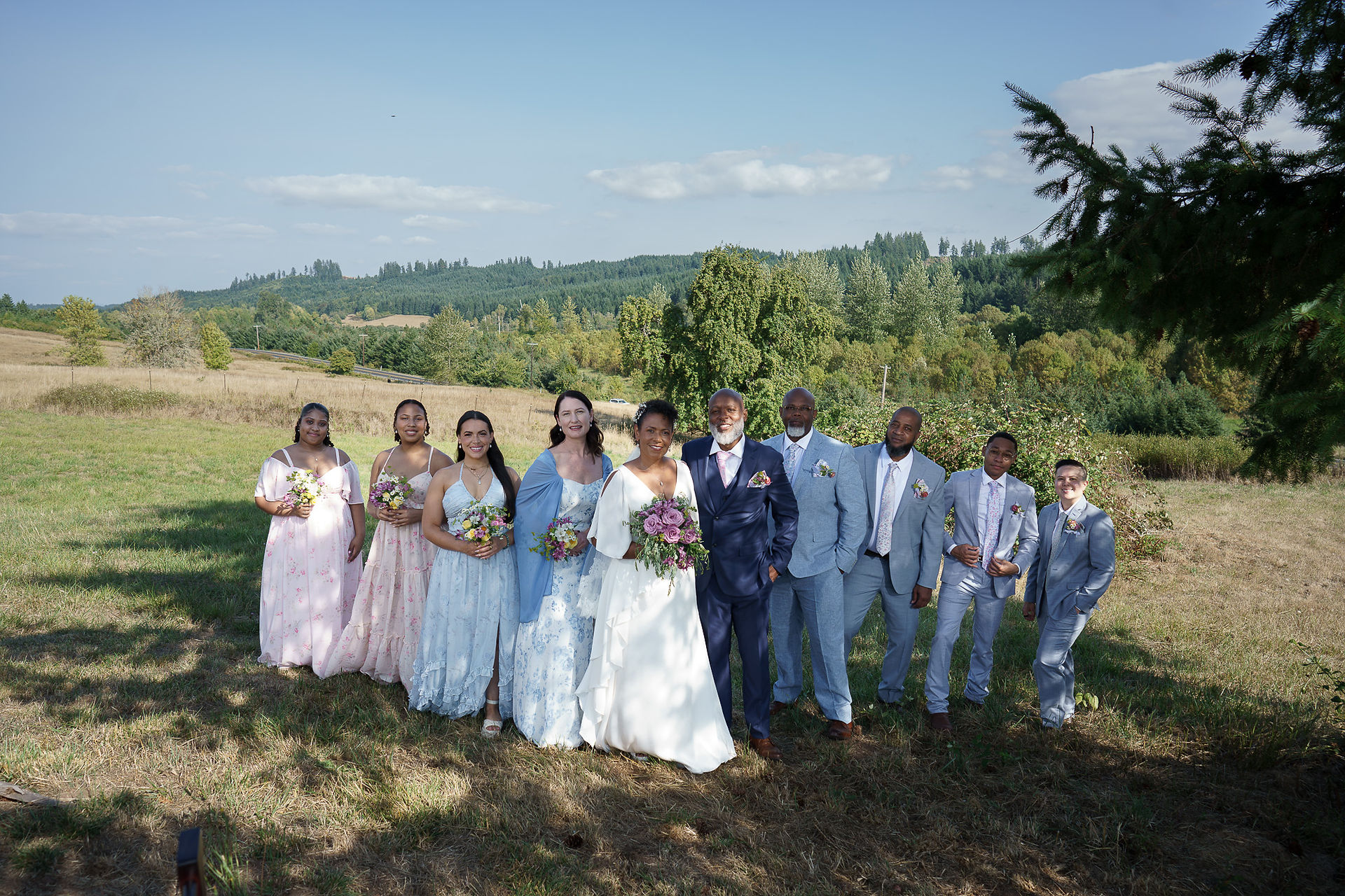Diverse wedding party posing together at an intimate farm wedding.
