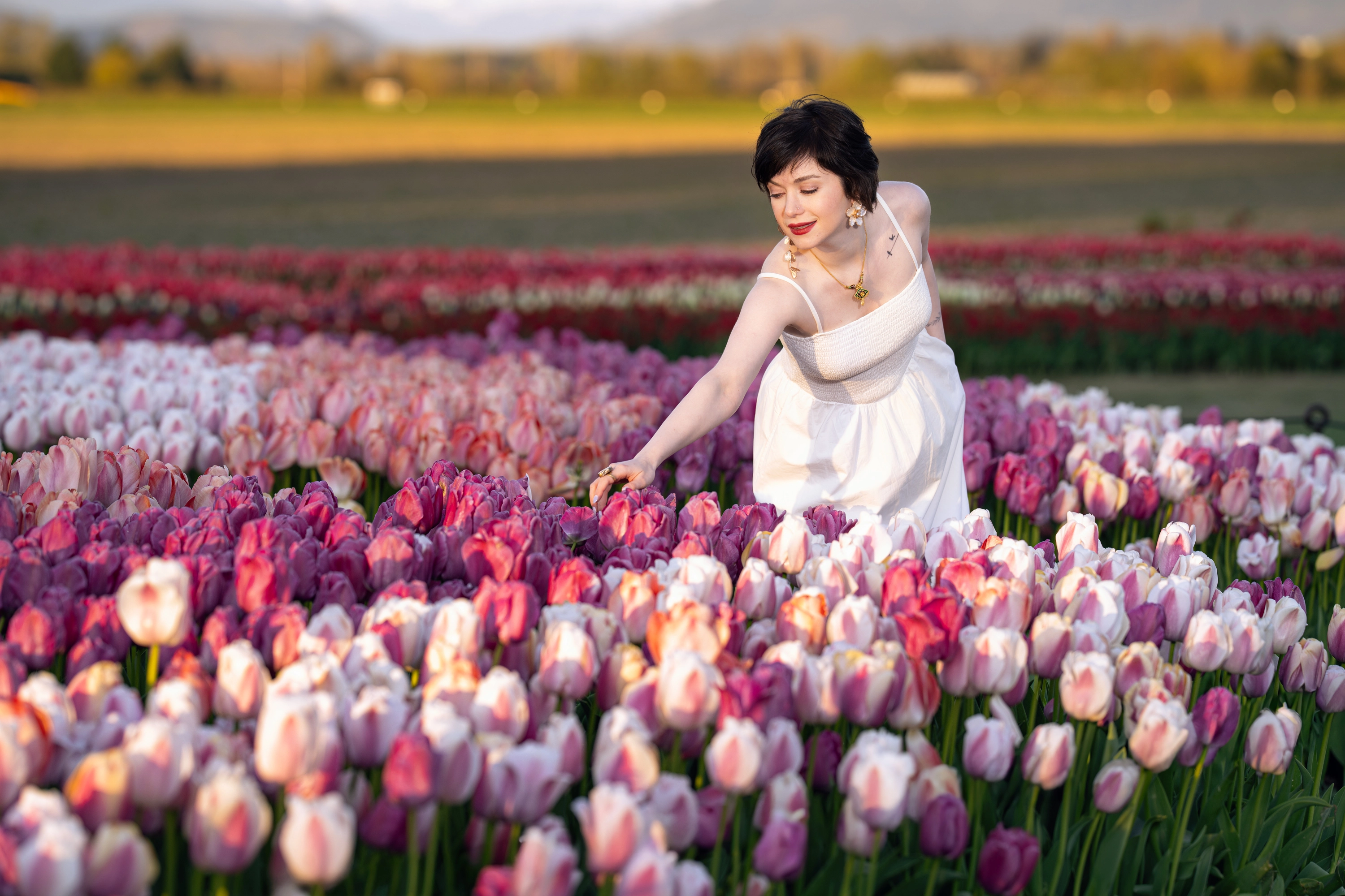 Woman in white dress touching tulips at Skagit Tulip Festival