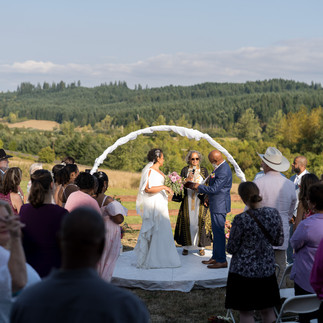 Bride and groom exchanging vows at an intimate farm wedding ceremony.