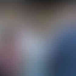 Guests holding a symbolic item at an outdoor farm wedding