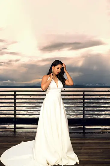 Bride in white gown, ocean view