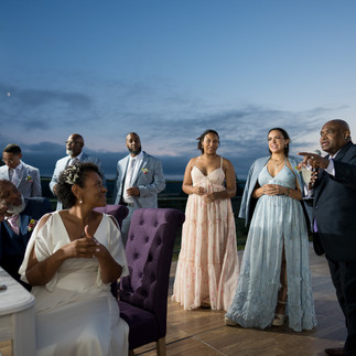 Guests gathered for an elegant outdoor evening celebration under twilight sky.