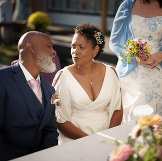 Bride and groom gazing lovingly during their intimate wedding ceremony.