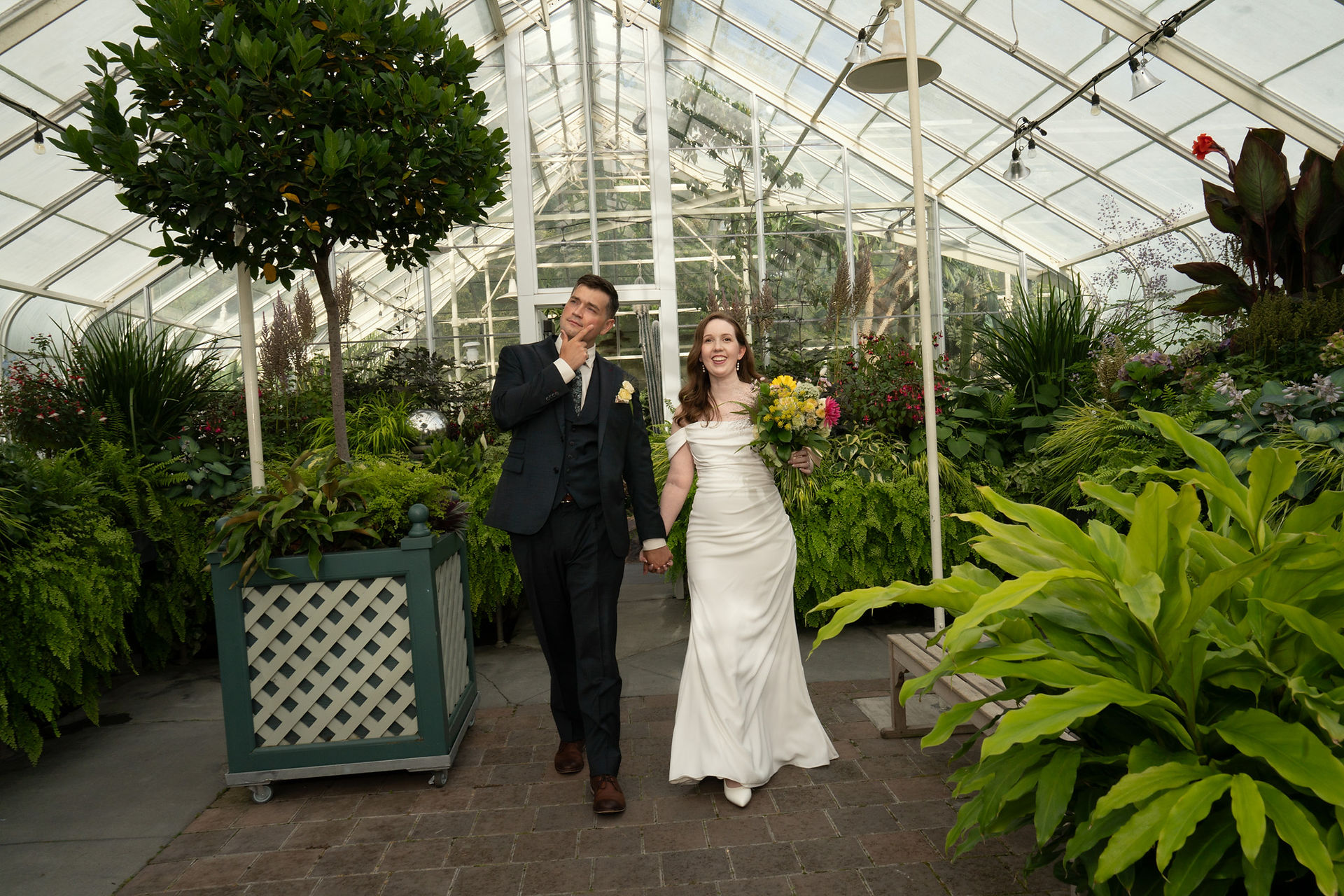 Couple at Volunteer Park Conservatory in Seattle wedding attire.