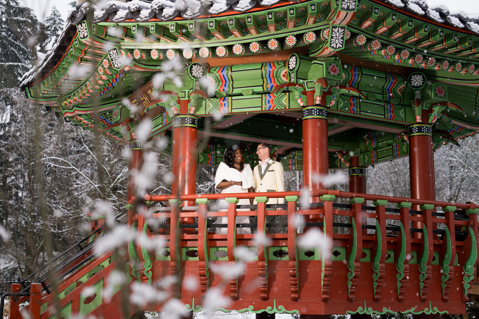 Wedding couple in a vibrant gazebo in snowy landscape