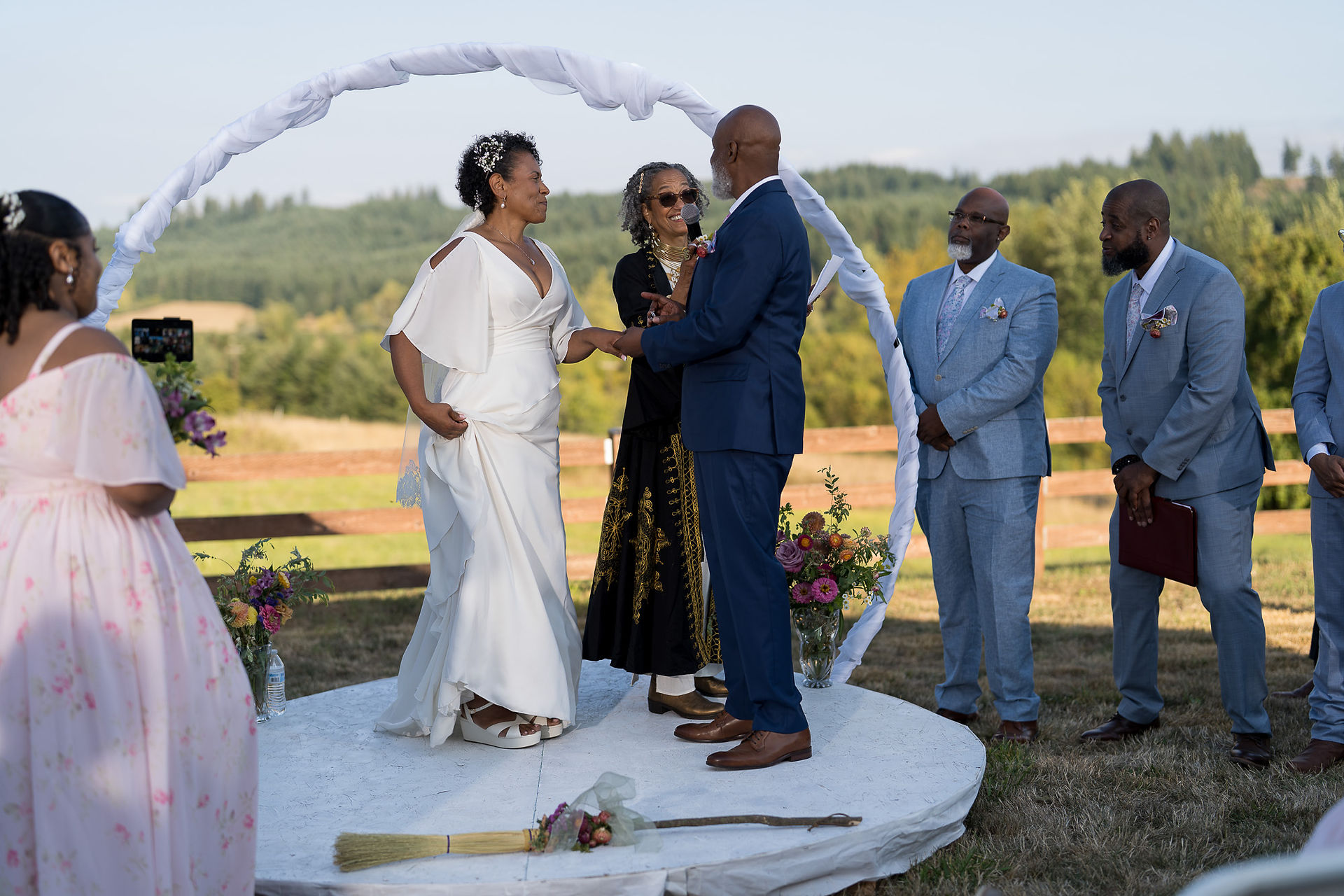 Couple exchanging vows during an intimate outdoor wedding ceremony on a farm.
