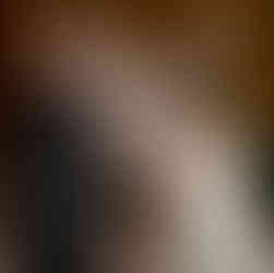 Bride and groom feeding each other cake at their wedding reception.