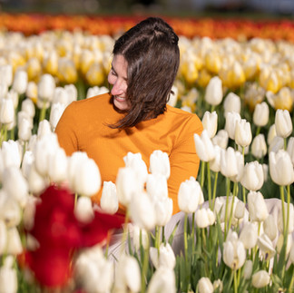 Smiling woman in white tulips at Skagit Tulip Festival