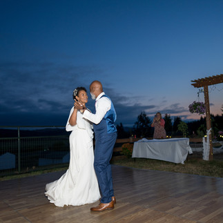 Wedding couple dancing at their intimate farm wedding reception at dusk.