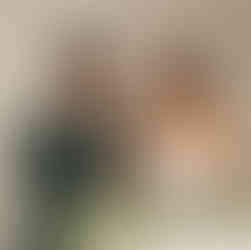 Smiling couple cuts white wedding cake together, a celebration moment.