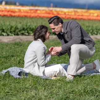 Man proposing to woman in tulip field at Skagit Tulip Festival.