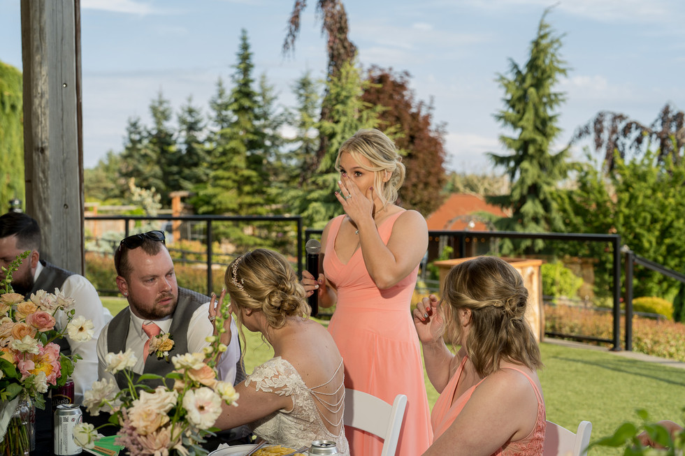 Emotional woman wipes tears giving speech at outdoor wedding. Olympic View Wedding Estates.