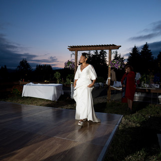 Bride in white dress on outdoor dance floor during intimate farm wedding.