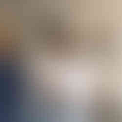 Two men adjust groom's tie, preparing for his wedding ceremony.